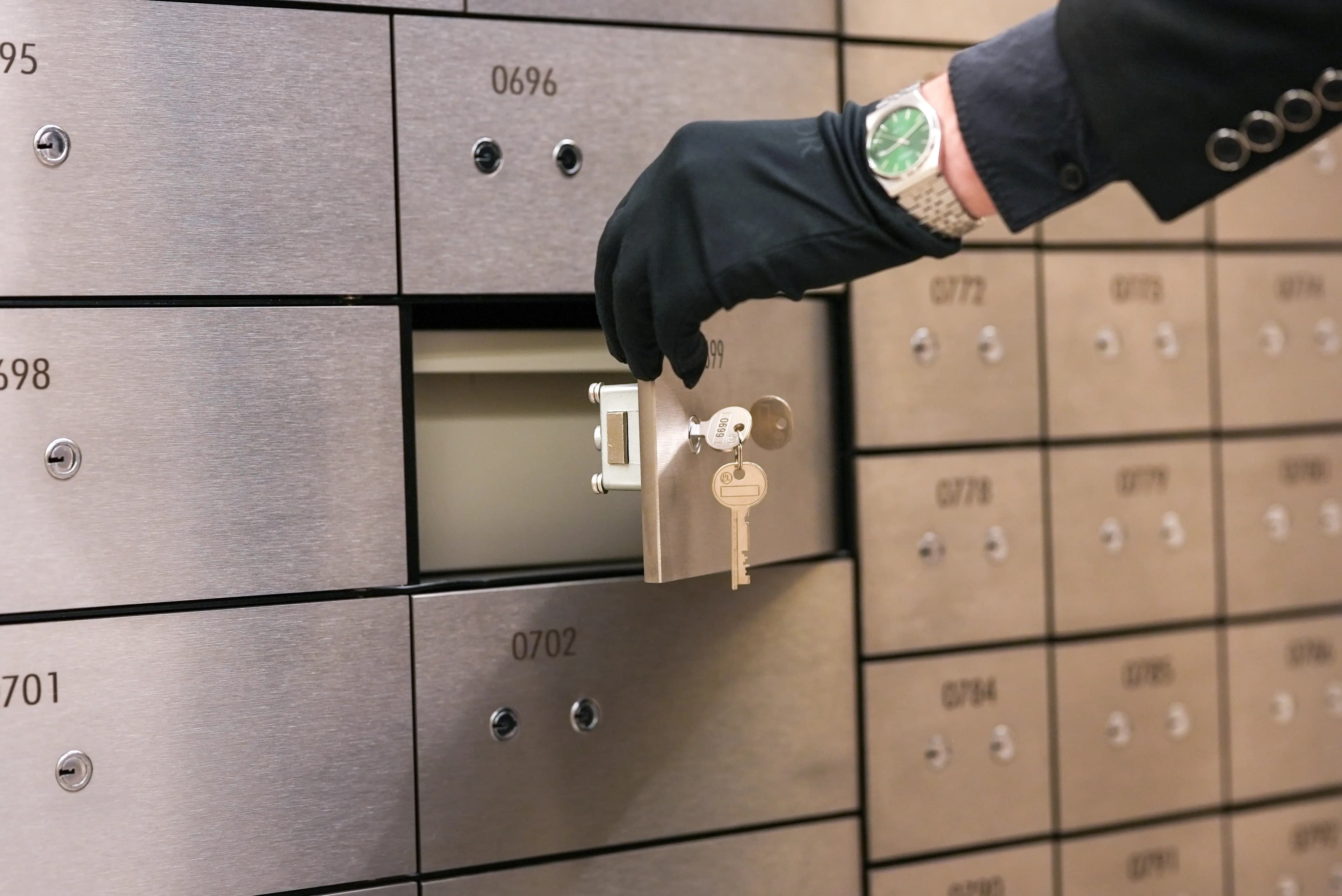 Hand opening a safe deposit locker