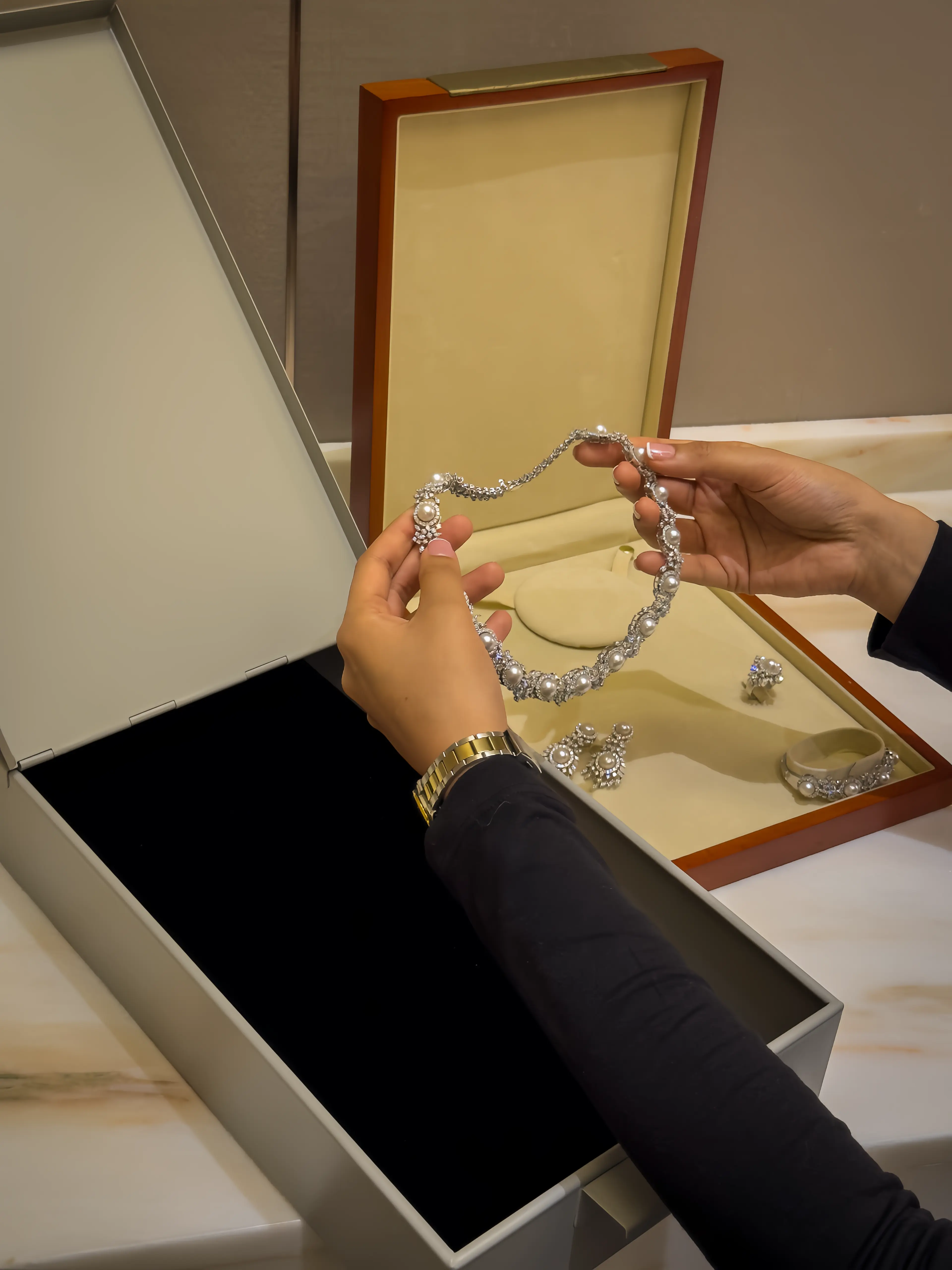 Hands holding necklace