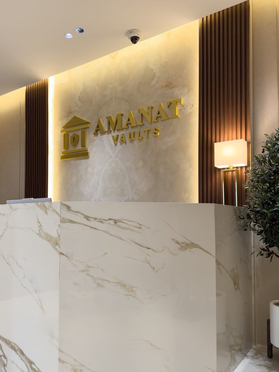 Amanat Vaults reception with marble counter and gold logo signage