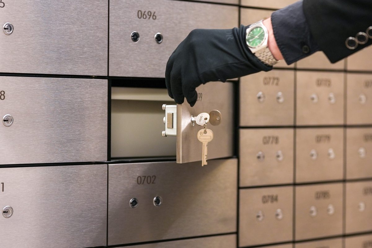 Gloved attendant retrieving a safe deposit box at Amanat Vaults